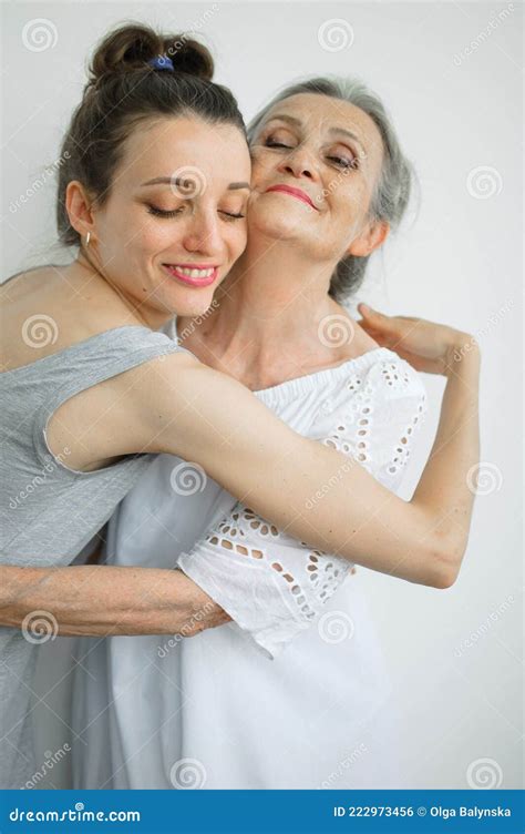 Happy Senior Mother Is Hugging Her Adult Daughter The Women Are Laughing Together Sincere