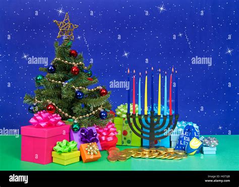 Christmas Tree With Presents Next To Hanukkah Menorah Burning Candles