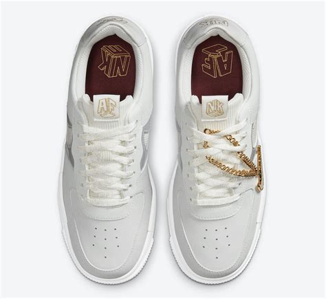 A geometric rendering of nike and af1 logos appear on the shoe's tongue tag, heel counter and insole. Nike Air Force 1 Pixel Grey Gold Chain DC1160-100 Release ...