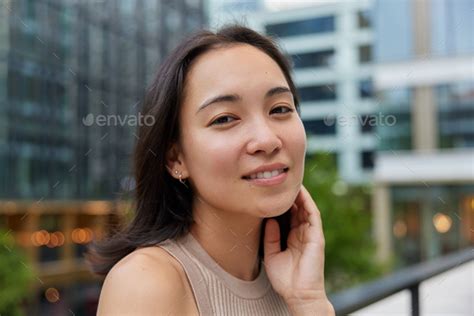 Portrait Of Good Looking Asian Woman With Dark Hair Has Healthy Smooth Skin Natural Beauty