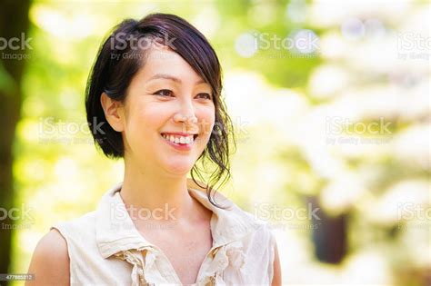 Beautiful Active Healthy Mature Japanese Woman In Park Looking Away