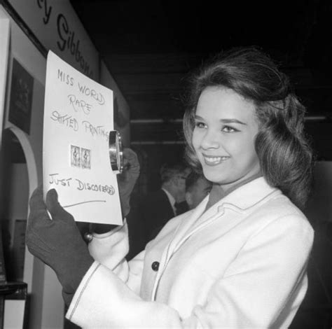 A Woman Holding Up A Piece Of Paper With Writing On It