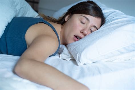 Face Close Up Portrait Of Woman Sleeping In Bed And Snoring Sinus