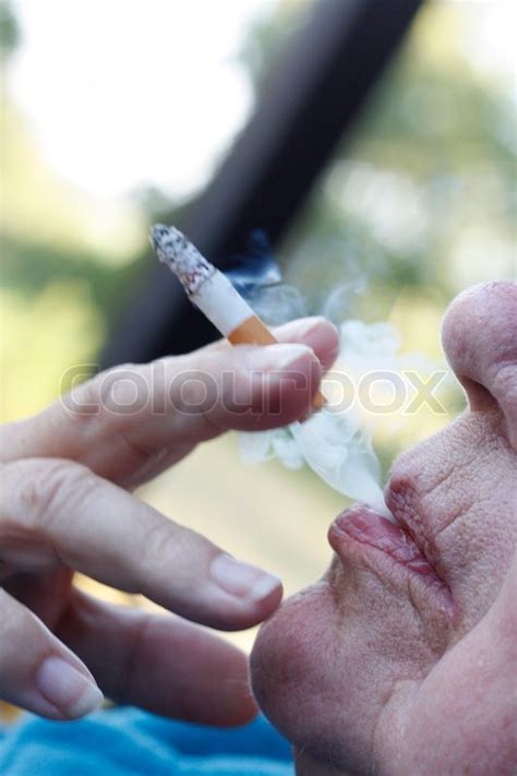 an elderly woman smoking a cigarette stock image colourbox