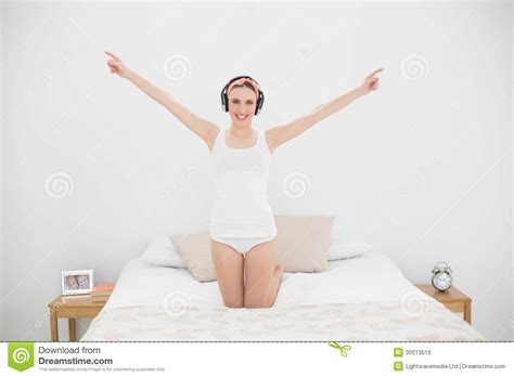 Young Woman Raising Her Arms While Listening To Music Stock Image Image Of Duvet Camera 35013519