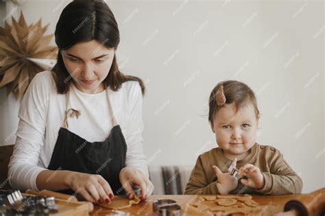 Linda Hijita Y Madre Haciendo Galletas De Jengibre Navideñas En Una