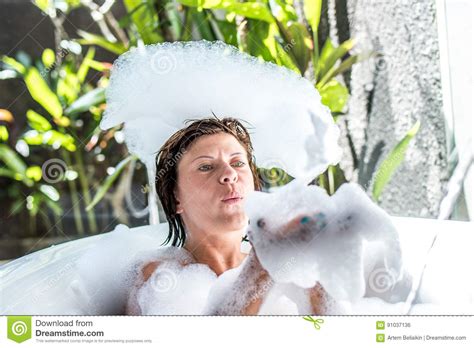 Young Woman Playing With Foam In Bathtub Tropical Bathroom In Luxury