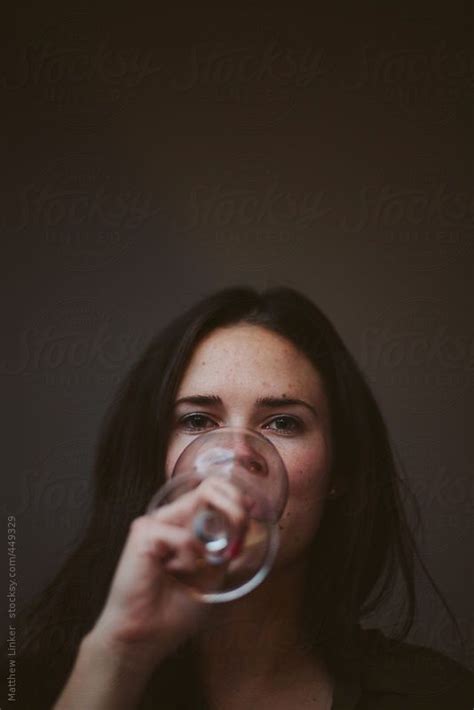 Young Woman Enjoying A Glass Of Wine By Matthew Linker