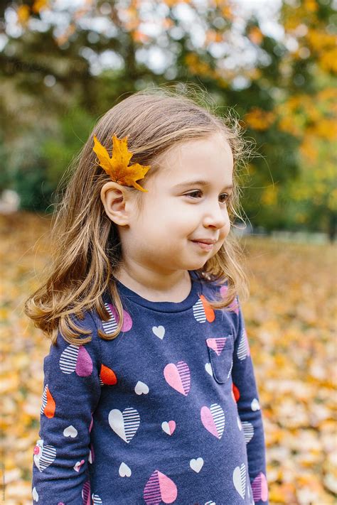 Cute Young Girl With A Leaf Behind Her Ear By Stocksy Contributor