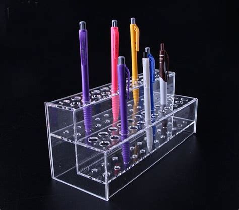 An Assortment Of Different Colored Pens In A Clear Holder