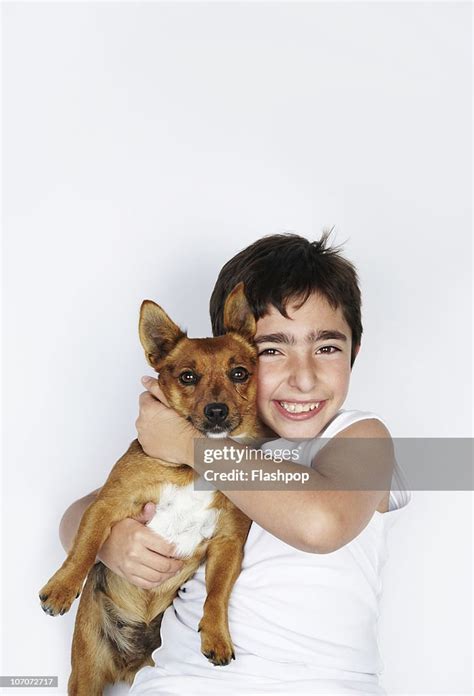 Portrait Of Boy Hugging His Pet Dog High Res Stock Photo Getty Images