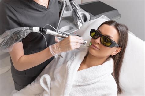 Premium Photo Cosmetologist Make Laser Hair Removal On Womans Face