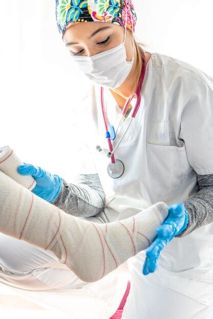 Premium Photo Crop Medic In Latex Gloves Wrapping Leg Of