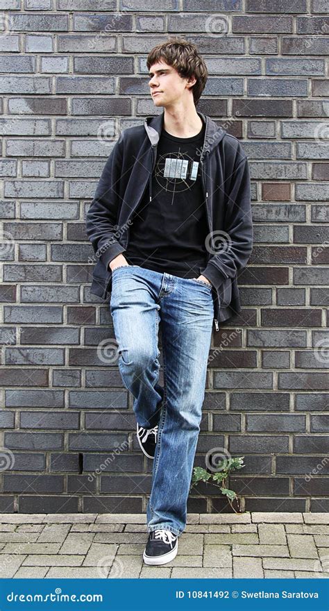 Portrait Of The Young Man Standing At A Wall Stock Photo Image Of