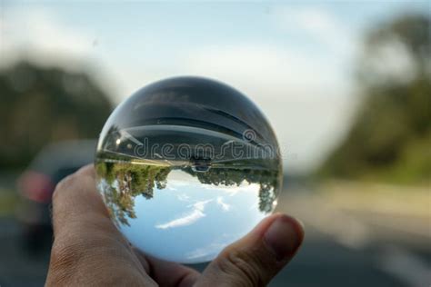 Man Holding A Crystal Ball In A Blue Clear Sky Stock Photo Image Of