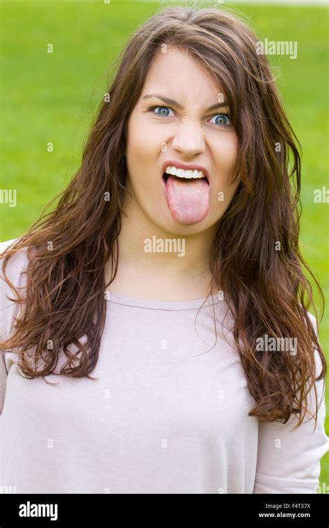 girl sticking tongue out photo stock alamy