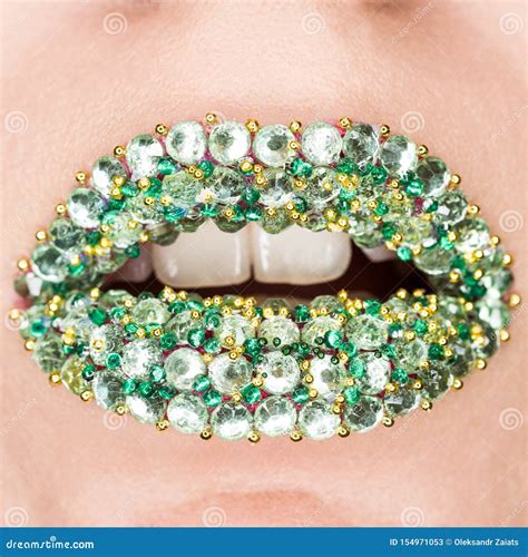 Closeup Of Fashion Green Lips With Green And Gold Gems On Lips Open