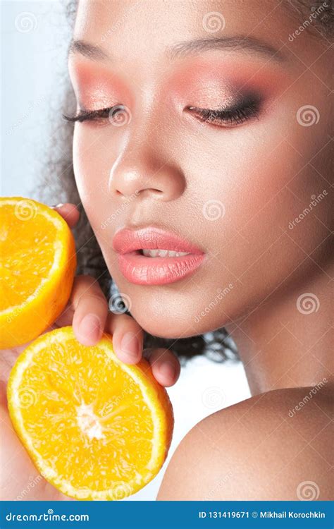 Young Beautiful Black Girl With Clean Perfect Skin With Lemon Close Up