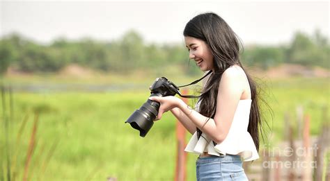 Cute Young Female Photographer With Camera Photograph By Sasin Tipchai