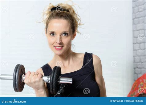 Portrait Of Young Woman Doing Fitness Exercise With Dumbbells A Stock