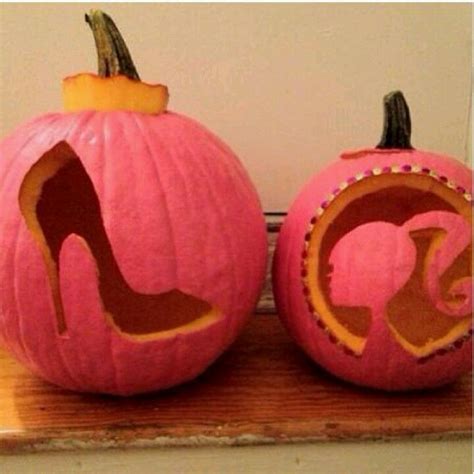 Two Pumpkins Decorated With High Heel Shoes On Top Of A Wooden Table