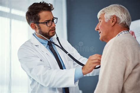 Taking Care Of The Elderly A Doctor Examining A Senior Patient With A