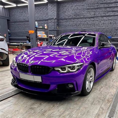 A Purple Car Is Being Worked On In A Factory