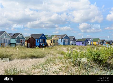 Colourful Painted Wooden Beach Huts Among The Sand Dunes At Mudeford
