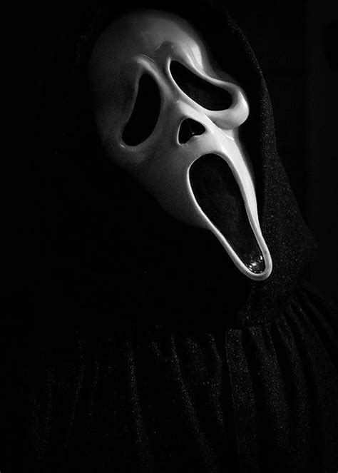 A Black And White Photo Of A Mask With The Word Scream On Its Face