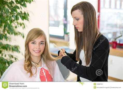 Hairdresser Cutting Customers Hair In Salon Stock