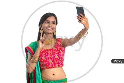 Image Of Portrait Of A Happy Young Traditional Indian Woman Taking