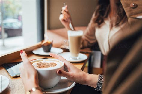 Women Drinking Coffee At A Cafe By Stocksy Contributor Lumina Stocksy