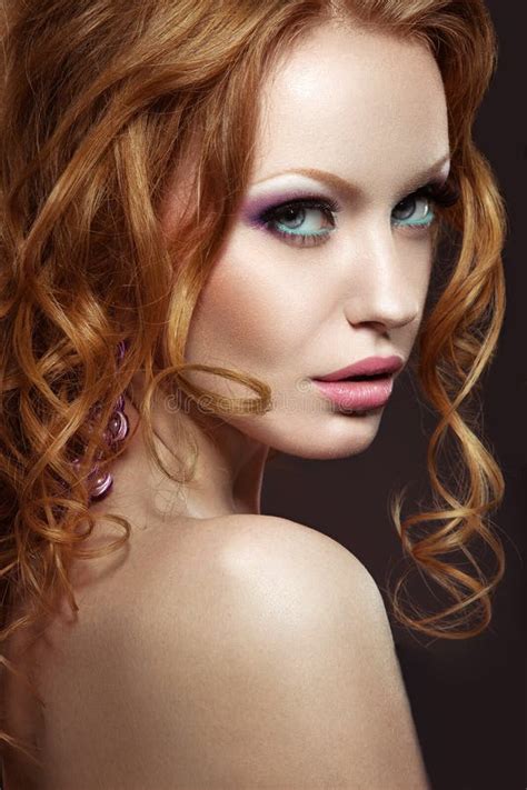 Beautiful Red Haired Girl With Bright Makeup And Curls Stock Photo