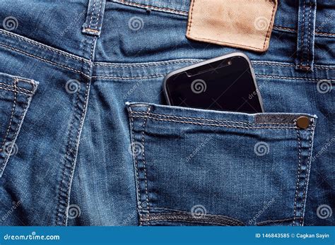 Black Smartphone In The Back Pocket Of An Indigo Vintage Blue Jean