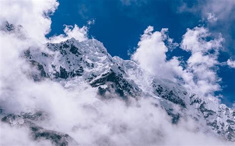 Download Wallpaper 1680x1050 Mountains Peaks Clouds Snow Sky