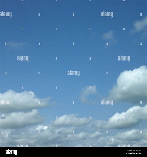 Puffy Clouds In Blue Sky Stock Photo Alamy