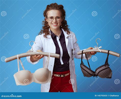 Doc Giving Comfortable Bra While Holding Bra In Other Hand Stock Image