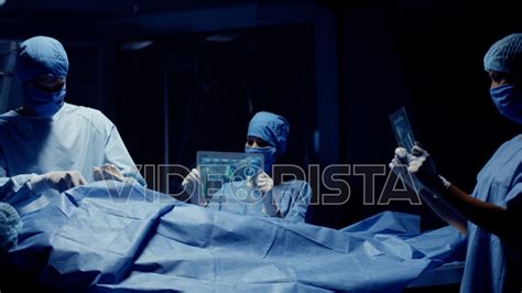 Team Of Medical Surgeons Use Futuristic Holographic Touchscreen Tablets
