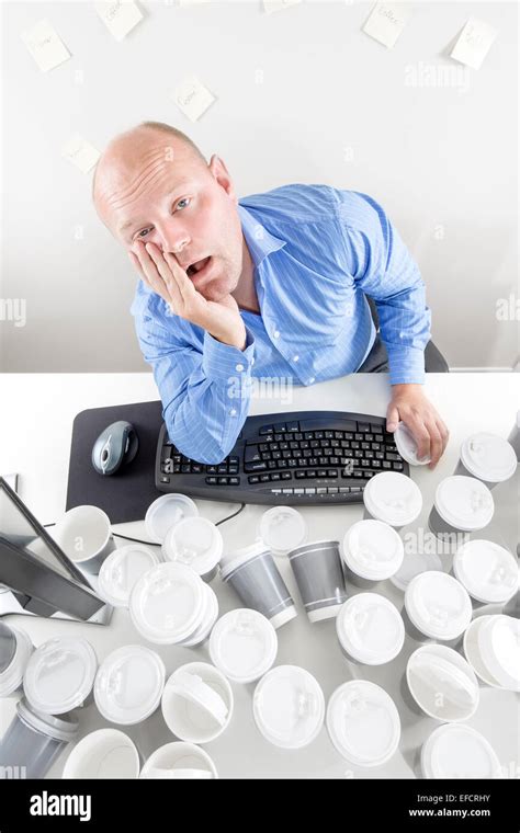 Overworked Man At The Office Stock Photo Alamy