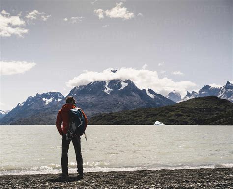 Backpacker Admiring View Of Grey Glacier In Torres Del Paine National