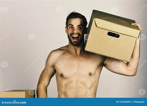 Man With Naked Torso Holding Cardboard Box On His Shoulder Macho With