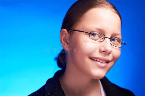Young Student In Eyeglasses Holds Folder And Smiling Stock Photo