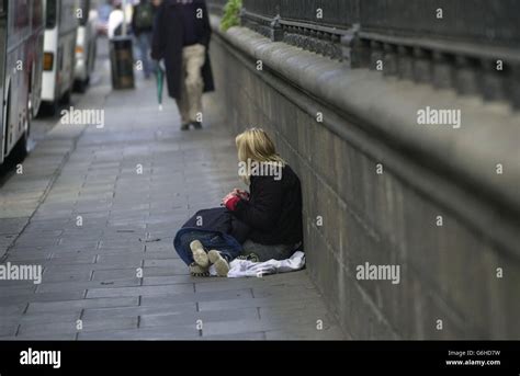 A Woman Begs With A Child On The Streets Of Dublin On The Day That