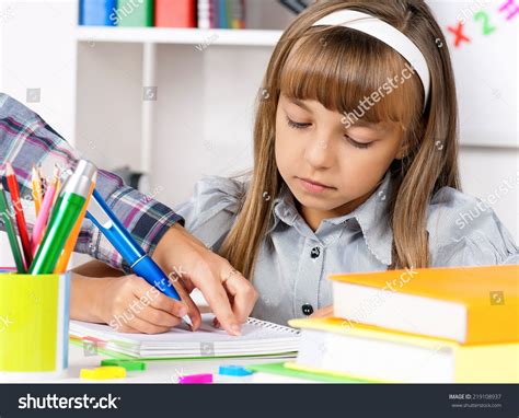 Little Girl Sitting Desk Classroom Doing Stock Photo 219108937