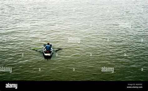 Man Alone In Row Boat Surrounded By Water Stock Photo Alamy