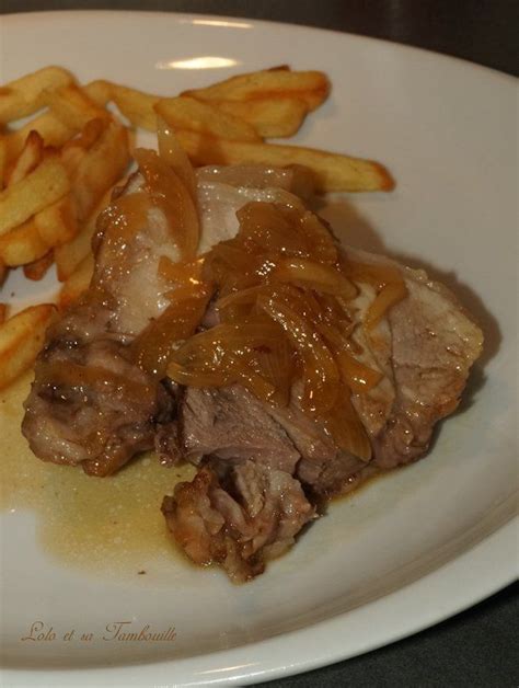 A White Plate Topped With Meat And French Fries