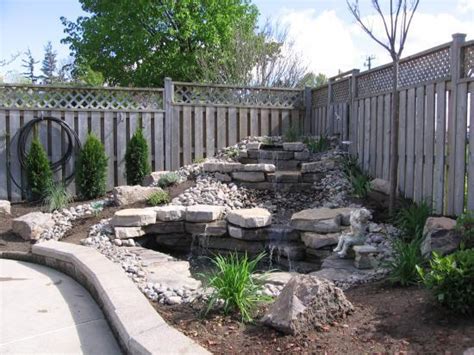 Ditch the idea of professional pond installations and get going to build one all by yourself with these. Backyard Waterfall | DoItYourself.com