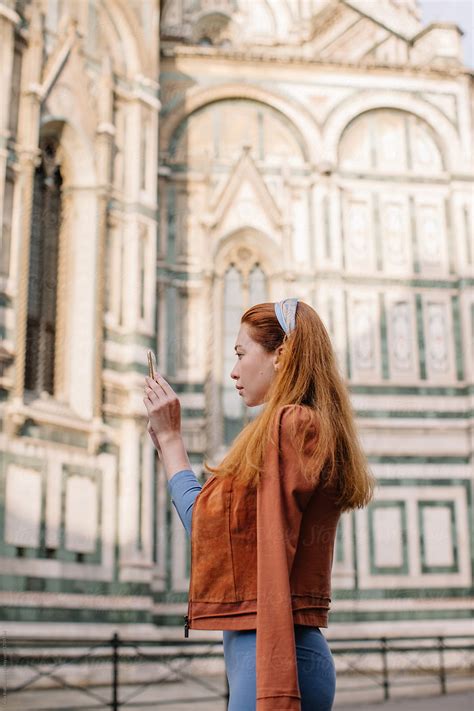 Side View Portrait Of Redhead Girl Taking Picture Of Duomo In Florence