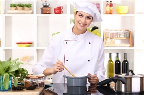 Young Woman Chef Cooking In Kitchen Stock Photo By ©belchonock 19159821