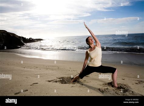 A Women At The Beach Performing Yoga Stock Photo Alamy